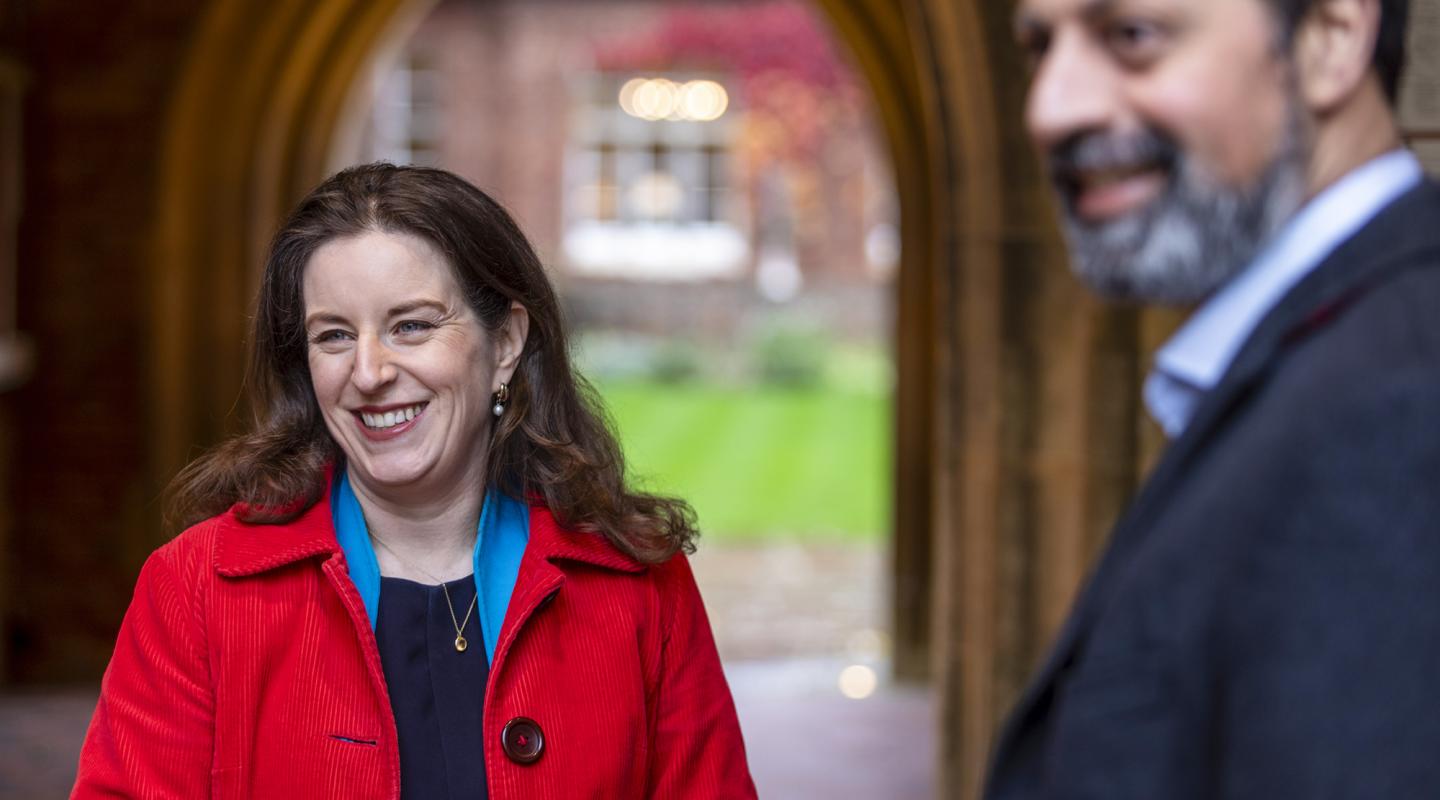 woman smiling in red coat