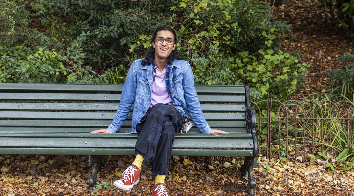 Smiling man on a bench outdoors