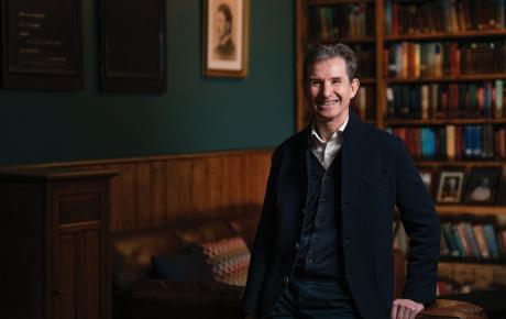 Portrait of man standing in a library