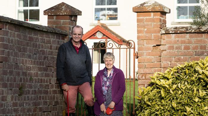 James and Linda outside their home in Devon