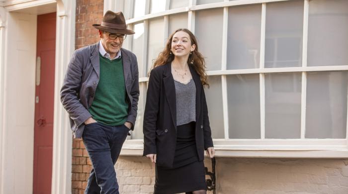 Man and woman walking along street 